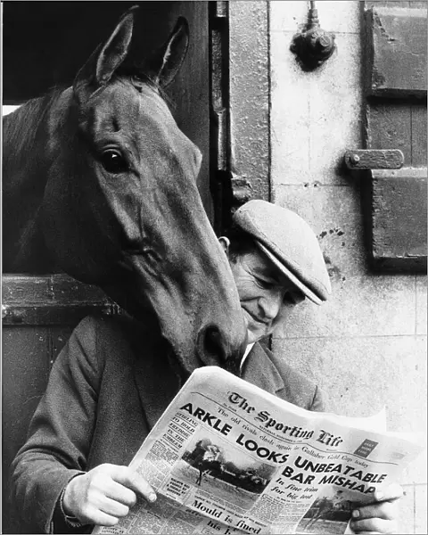 Famous racehorse Arkle looking over the shoulder of head lad Paddy Murray reading