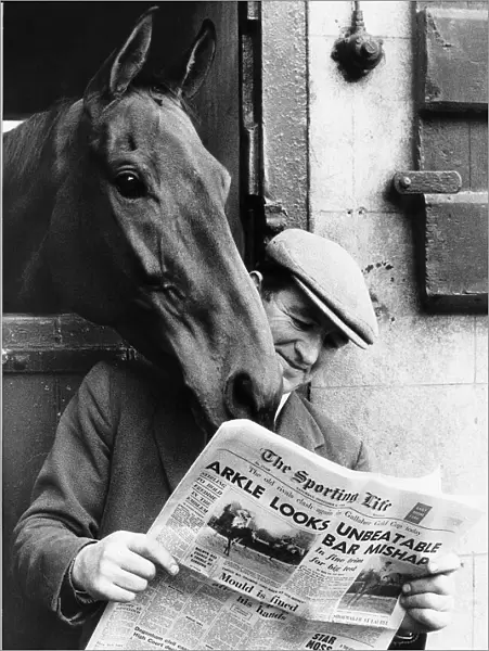 Famous racehorse Arkle looking over the shoulder of head lad Paddy Murray reading