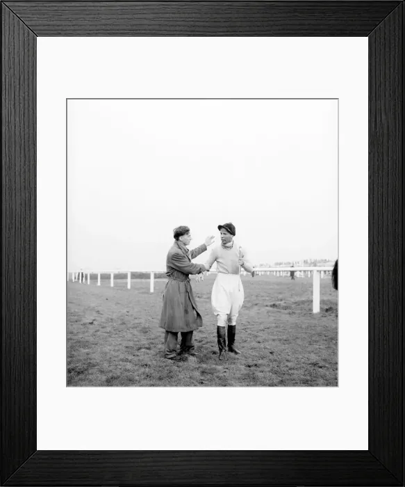 Framed Print : Grand National at Aintree Racecourse. Dejected jockey Dick Francis receives Framed Print : Grand National at Aintree Racecourse. Dejected jockey Dick Francis receives