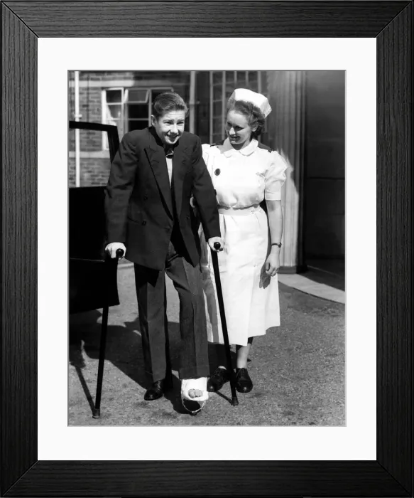 Framed Print : Lester Piggott with a nurse and broken foot or toe. 15th September 1951 Framed Print : Lester Piggott with a nurse and broken foot or toe. 15th September 1951