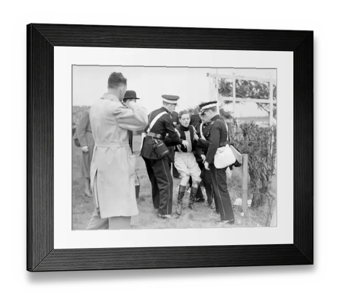 Framed Print : Injured jockey R Curran (Ulster Monarch) is helped to his feet in The Grand National