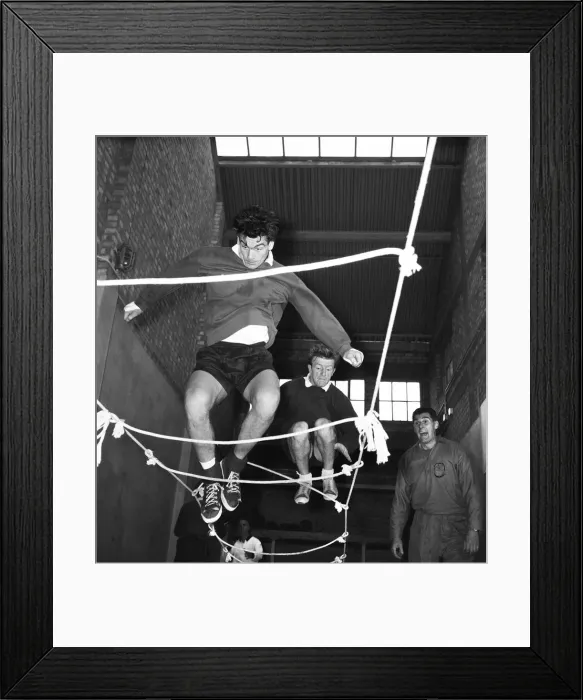 Framed Print : Tottenham Hotspur footballers Ron Henry and Terry Dyson using a rope ladder during a team Framed Print : Tottenham Hotspur footballers Ron Henry and Terry Dyson using a rope ladder during a team