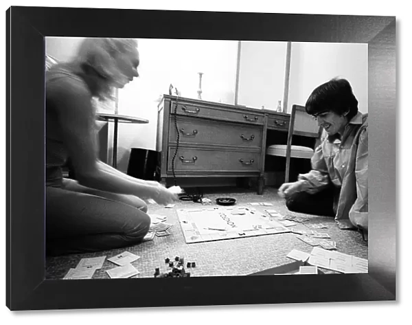 George Harrison enjoys a game of Monopoly with singer songwriter Jackie de Shannon