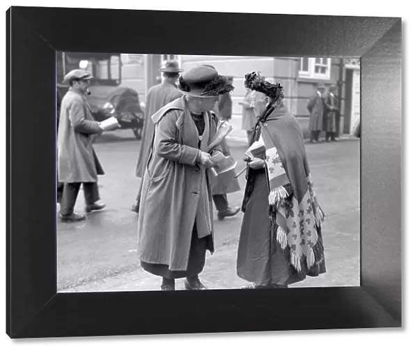 Old Kate the tipster at the Derby gives a tip to a woman punter, June 1924