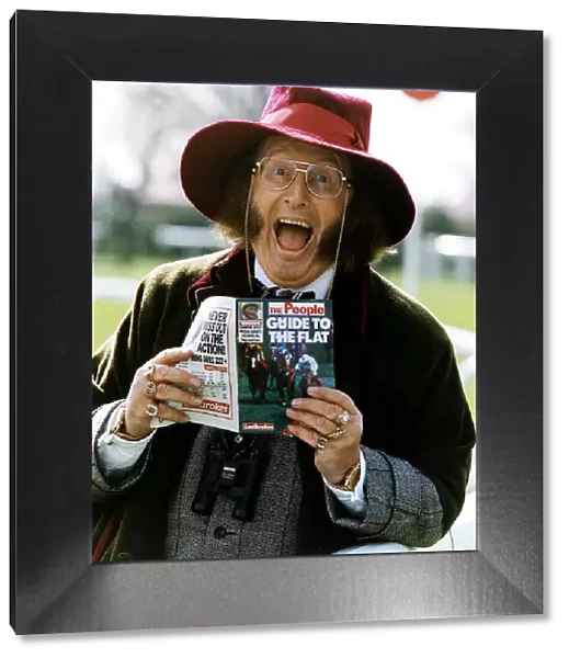 Horse Racing Journalist John McCririck, holding a copy of the People Guide to Flat Racing