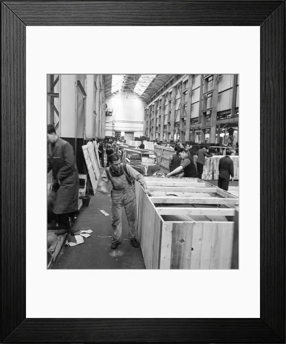 Framed Print : Morris Minor Low Light Sedans fresh of the production line being packed for export Framed Print : Morris Minor Low Light Sedans fresh of the production line being packed for export