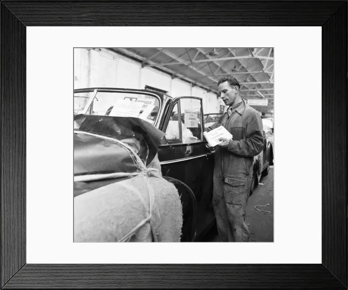 Framed Print : Morris Minor Low Light Sedans fresh of the production line after being packed for Framed Print : Morris Minor Low Light Sedans fresh of the production line after being packed for