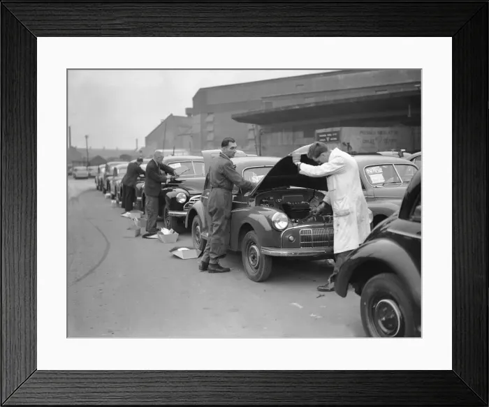 Framed Print : Morris Minor Low Light Sedans fresh of the production line seen here being prepared for Framed Print : Morris Minor Low Light Sedans fresh of the production line seen here being prepared for