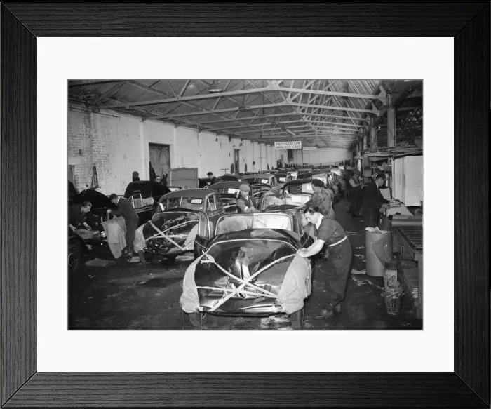 Framed Print : Morris Minor Low Light Sedans fresh of the production line being packed for export Framed Print : Morris Minor Low Light Sedans fresh of the production line being packed for export
