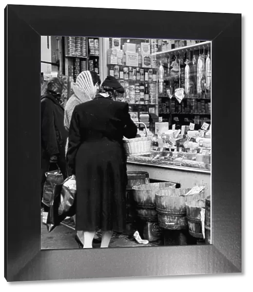 Women looking in a shop window on Brewer Street, Soho. Circa 1955