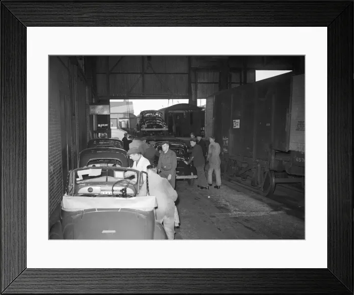 Framed Print : Morris Minor Low-Light Sedans fresh of the production line packed for export Framed Print : Morris Minor Low-Light Sedans fresh of the production line packed for export
