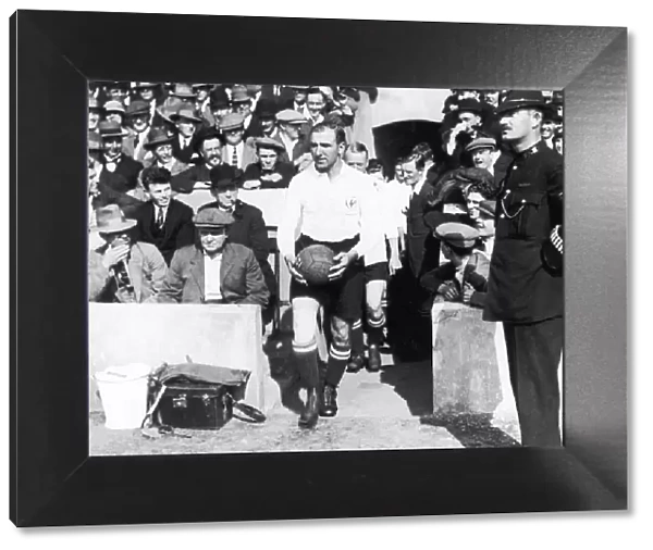 Tottenham Hotspur captain Arthur Grimsdell leads out his team for a match, circa 1920