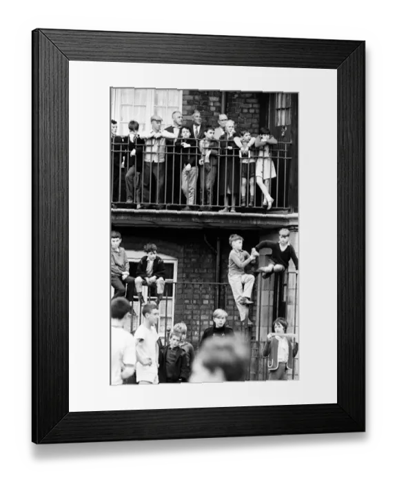 Framed Print : Liverpool mananer Bill Shankly watches a game of Street football from a flat above Eldon