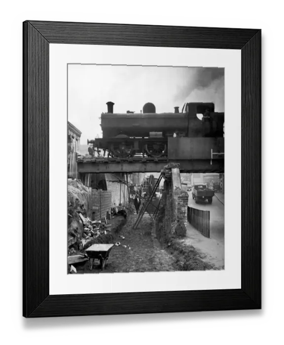Framed Print : A goods train makes its way across the tow bridge in the centre of Stourbridge as it is Framed Print : A goods train makes its way across the tow bridge in the centre of Stourbridge as it is