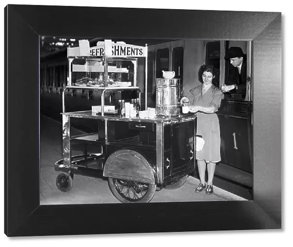 A female worker at Snow Hill Railway station in Birmingham serves a cup of tea from her