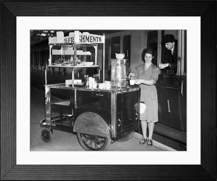 Framed Print : A female worker at Snow Hill Railway station in Birmingham serves a cup of tea from her Framed Print : A female worker at Snow Hill Railway station in Birmingham serves a cup of tea from her