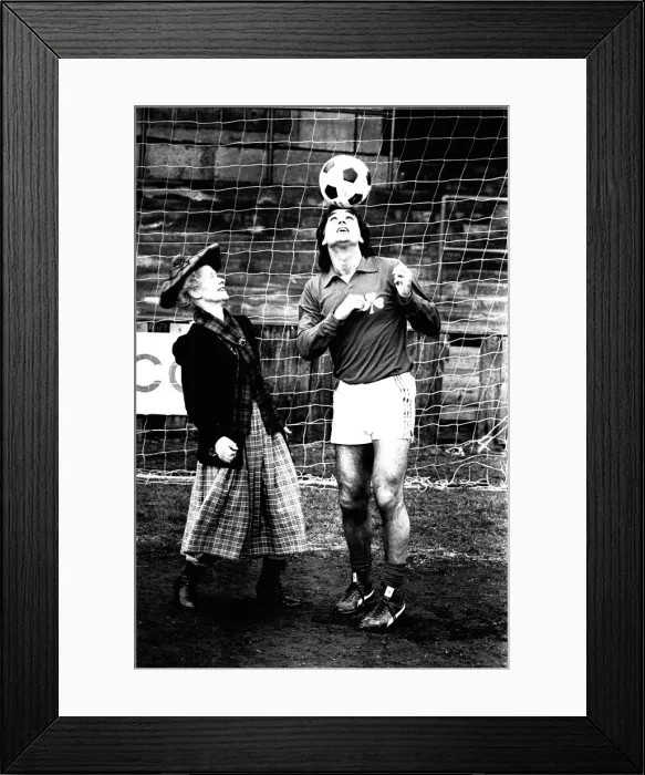 Framed Print : Lib - Football legend George Best giving actress Gudrun Ure some footballing tips during Framed Print : Lib - Football legend George Best giving actress Gudrun Ure some footballing tips during