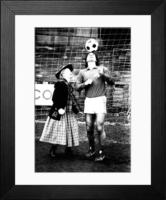 Framed Print : Lib - Football legend George Best giving actress Gudrun Ure some footballing tips during Framed Print : Lib - Football legend George Best giving actress Gudrun Ure some footballing tips during