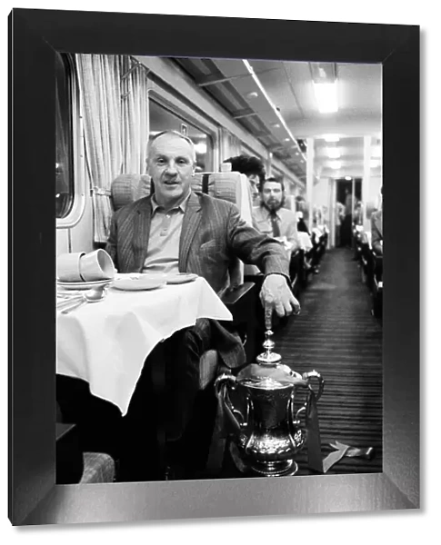 Liverpool manager Bill Shankly with the FA Cup trophy on board the train back to