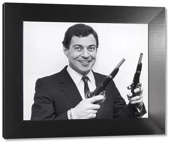 Birmingham Comedian, David Ismay seen posing with a gun in either hand
