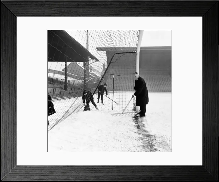Framed Print : Liverpool manager Bill Shankly helps to clear the snow from the goal line on the Anfield Framed Print : Liverpool manager Bill Shankly helps to clear the snow from the goal line on the Anfield
