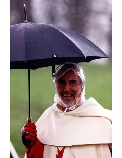 Actor Christopher Lee well protected from the weather during filming of Ivanhoe for