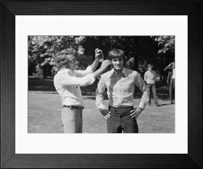 Framed Print : Manchester United footballer George Best has hair spray applied by his personal