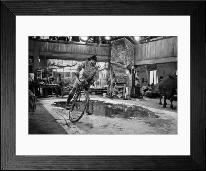 Framed Print : Tony Hancock rides a bike around the set as he films The Rebel at Elstree