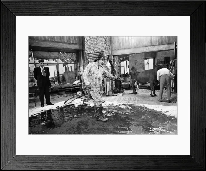 Framed Print : Tony Hancock rides a bike around the set as he films The Rebel at Elstree