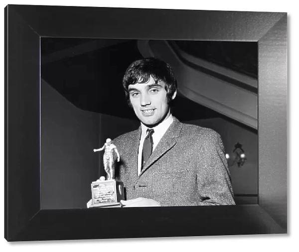 Manchester United star George Best holding his Footballer of the Year trophy