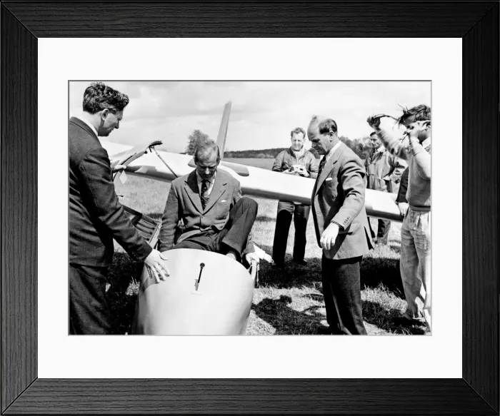 Framed Print : Prince Philip climbs into the cockpit while Peter Scott Looks on (right) Framed Print : Prince Philip climbs into the cockpit while Peter Scott Looks on (right)