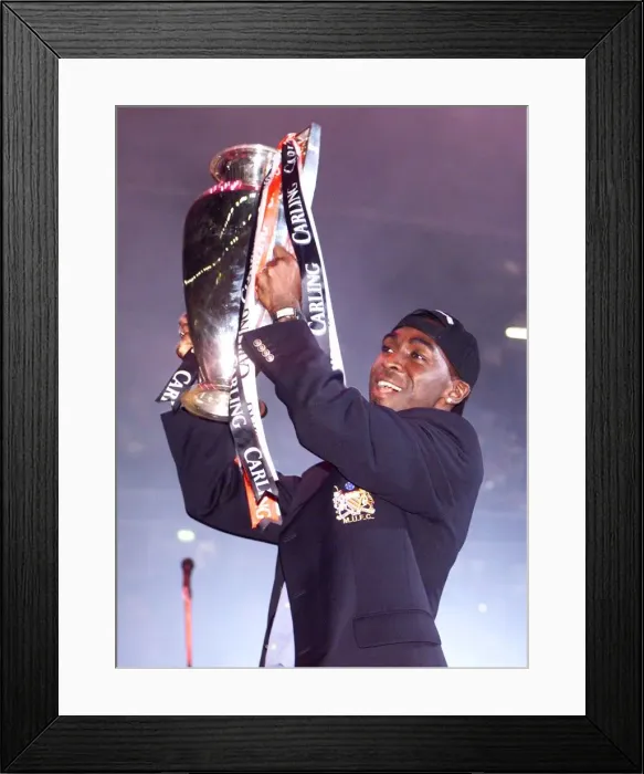 Framed Print : Andy Cole celebrating with the League trophy May 1999 in Manchester Arena as