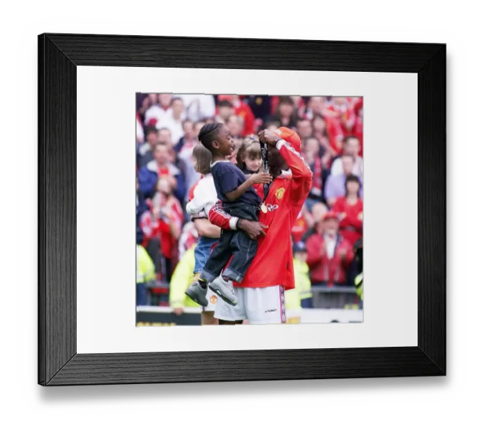Framed Print : Andy Cole Football player for Manchester United May 1999 showing his son Devante Framed Print : Andy Cole Football player for Manchester United May 1999 showing his son Devante