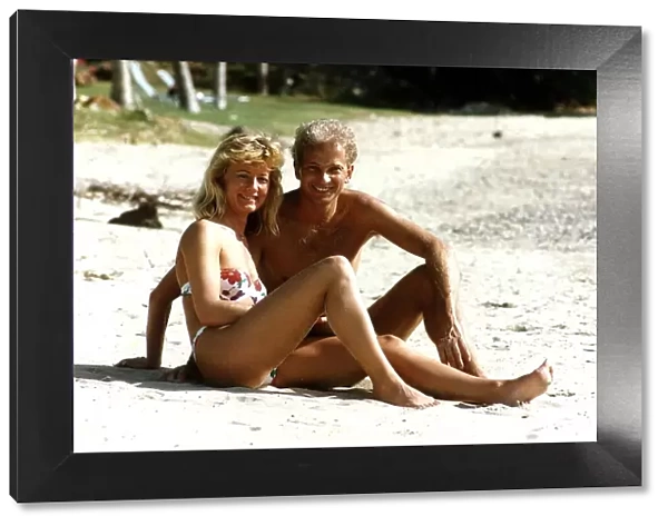 Cricketer David Gower cricketer with girlfriend Thorrun Nash on the beach during their