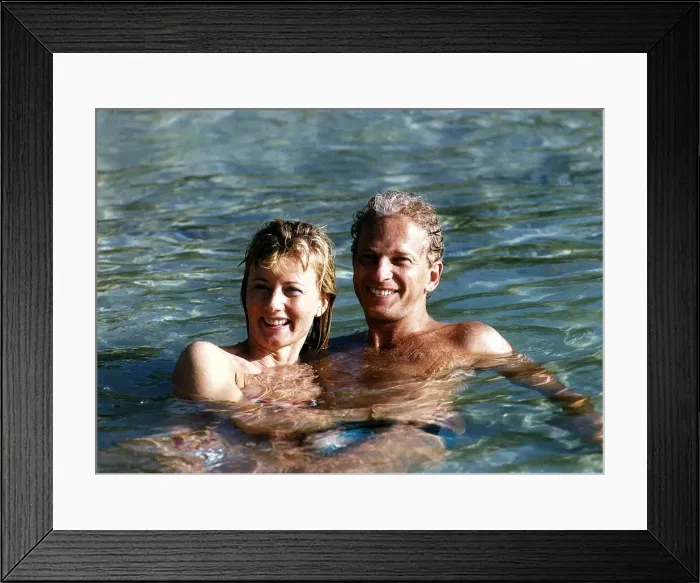 Framed Print : David Gower cricketer with Thorrun Nash in the sea during their visit to the West Indies Framed Print : David Gower cricketer with Thorrun Nash in the sea during their visit to the West Indies