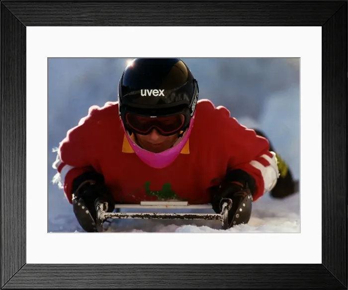 Framed Print : David Gower former England Cricket Captain lays on sledge in snow during a skiing break