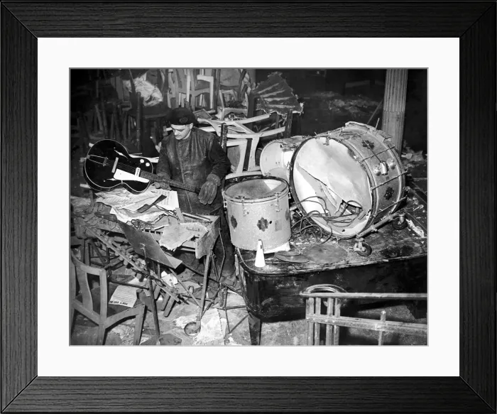 Framed Print : Salvage workers sort through the damaged band instruments at the Cafe de Paris following