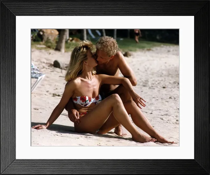 Framed Print : Cricketer David Gower cricketer with girlfriend Thorrun Nash on the beach during their Framed Print : Cricketer David Gower cricketer with girlfriend Thorrun Nash on the beach during their