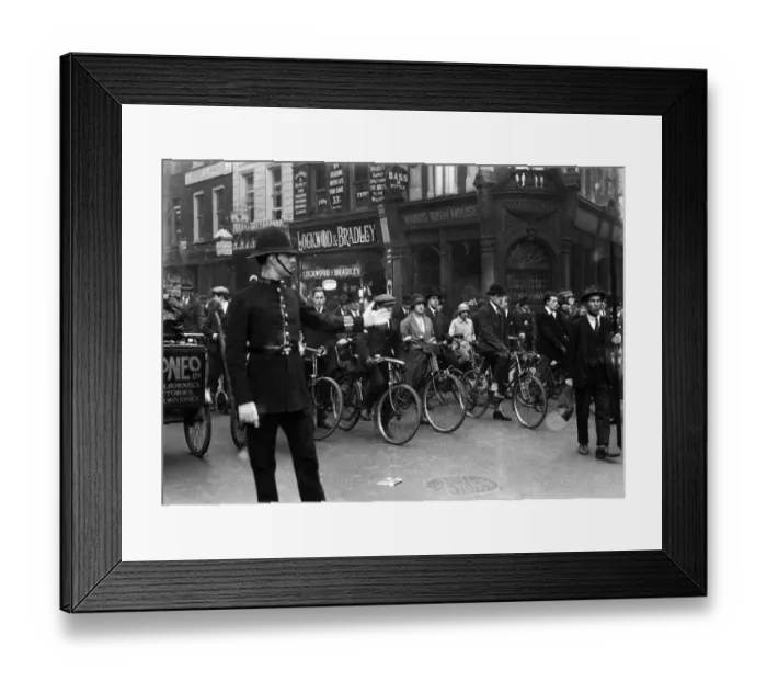 Framed Print : Policeman on traffic duty seen here directing cyclist and pedestrians on High Holborn Framed Print : Policeman on traffic duty seen here directing cyclist and pedestrians on High Holborn