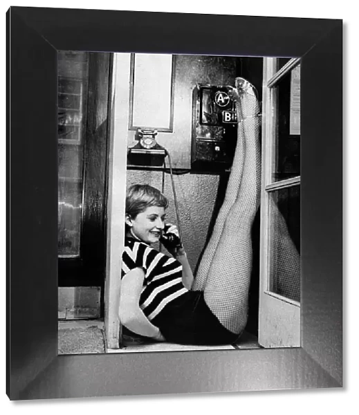 Jill Ireland actress in telephone booth, March 1955