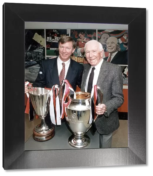 Manchester United manager Alex Ferguson and former manager Sir Matt Busby posing with