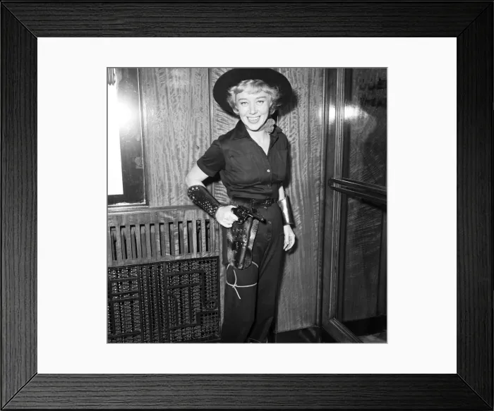 Framed Print : Premiere of Cowboy at Odeon Leicester Square. Actress Glynis Johns hods a gun in it