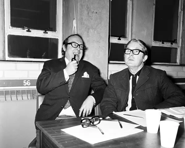 Eric Morecambe and Ernie Wise, working on a script for their show