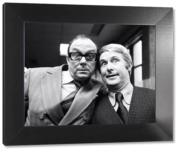 Eric Morecambe and Ernie Wise, still able to enjoy a laugh as they take a break