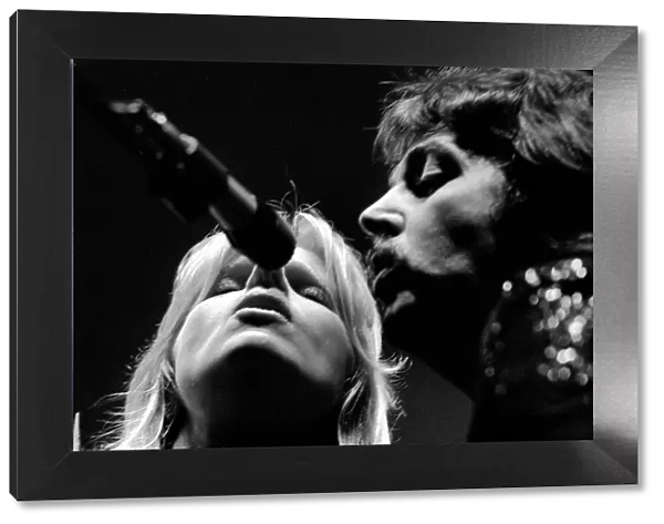 Paul McCartney, formerly of The Beatles, singing with his wife Linda as part of their