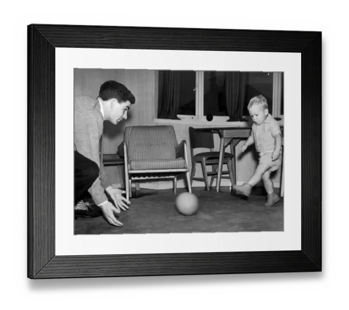 Framed Print : Birmingham City footballer Eddie Brown pictured at home in Sheldon playing with his two Framed Print : Birmingham City footballer Eddie Brown pictured at home in Sheldon playing with his two