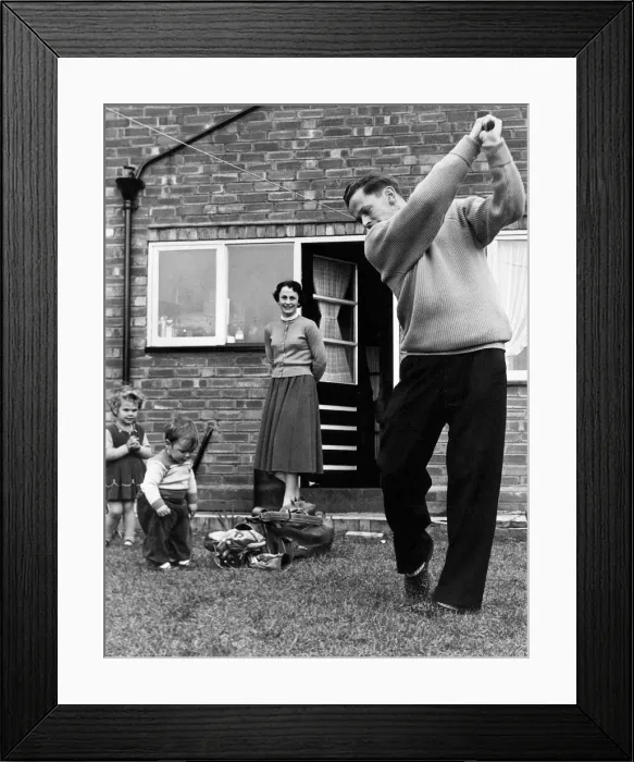 Framed Print : Birmingham City footballer Gordon Astall practices his golf swing at home in his back Framed Print : Birmingham City footballer Gordon Astall practices his golf swing at home in his back