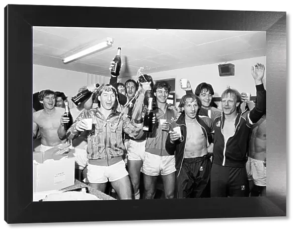 Birmingham City players celebrate with champagne in the dressing room after they clinched