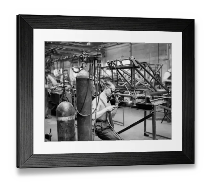 Framed Print : A welder constructs the fuselage framework of the Miles 3 Falcon aircraft at the Philips Framed Print : A welder constructs the fuselage framework of the Miles 3 Falcon aircraft at the Philips