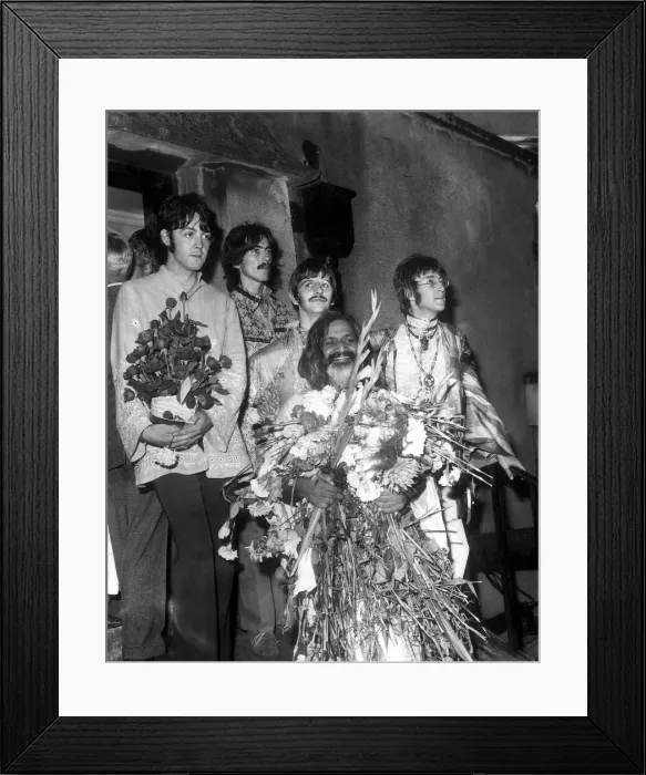 Framed Print : The Beatles with the Maharishi Mahesh Yogi who is clutching bundles of flowers Beatles
